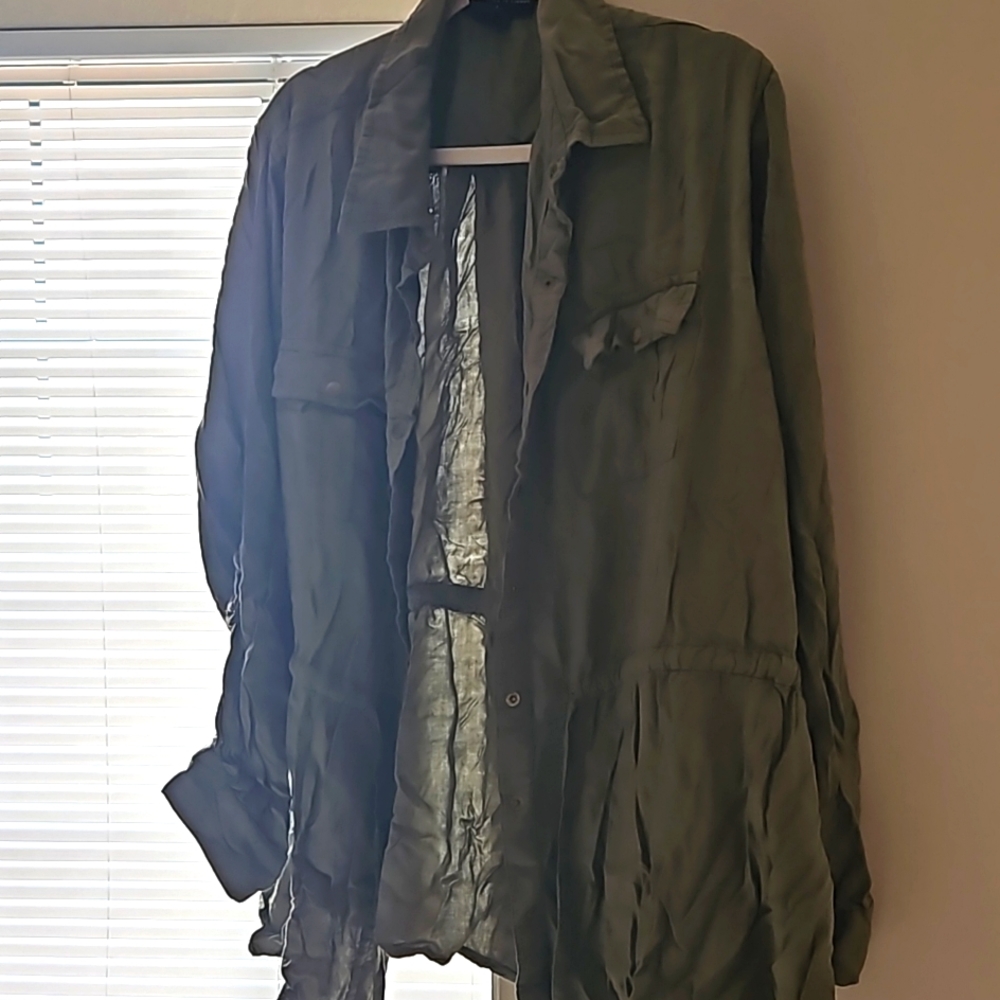 A navy green blouse with two pockets and waist strings to adjust.